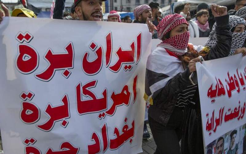 روی پلاکارد معترضان نوشته شده: ایران بیرون، آمریکا بیرون، بغداد آزاد