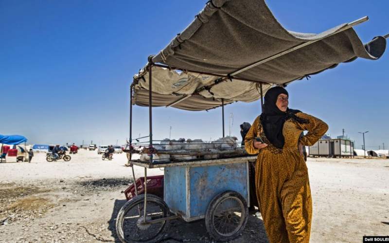 زن سوری آواره در کنار گاری خود