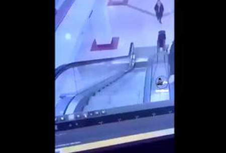 پرت شدن مرد از پله برقی بر اثر لگد یک دیوانه